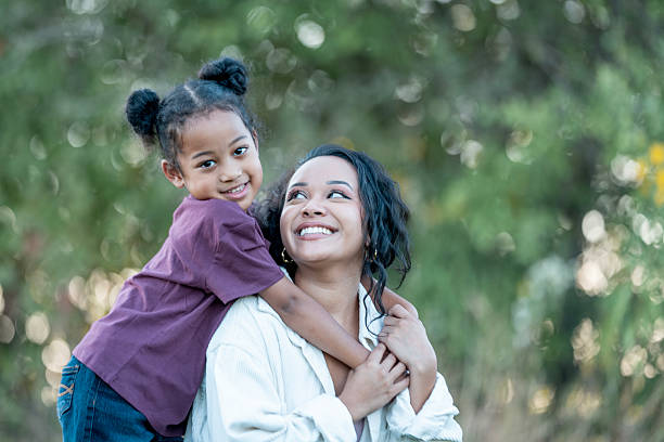 istock Smiling Mother and Daughter Bonding Outdoors in a Green Natural Setting 2235936352