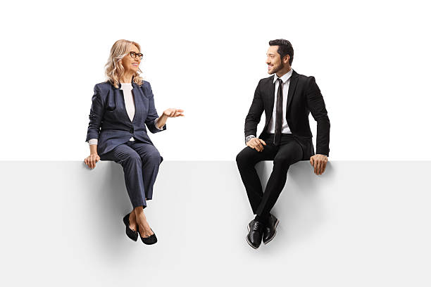 istock Woman talking to a businessman and sitting on a blank panel 2235937468