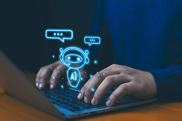 istock Hands typing on laptop with glowing AI chatbot icon, symbolizing artificial intelligence, customer support automation, assistant, online communication, machine learning, and future business technology 2235938132