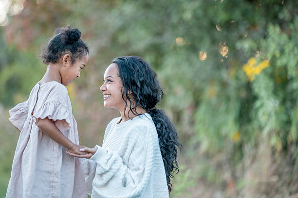 istock Mother and Daughter Sharing a Joyful Moment Outdoors in Nature 2235940962