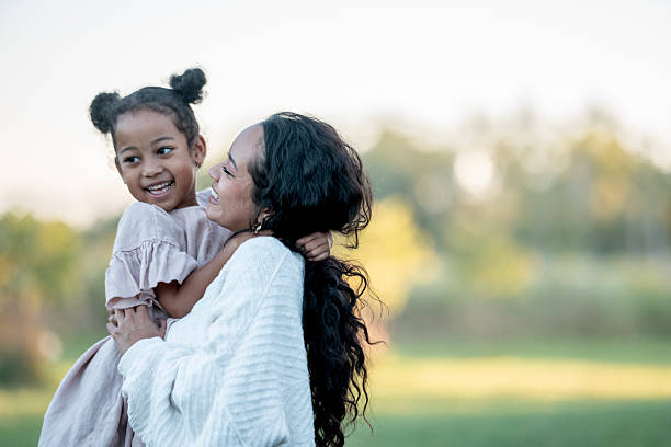 istock Mother and Daughter Bonding Outdoors on a Sunny Day 2235941644