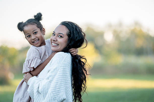 istock Happy Mother and Child Smiling Outdoors on a Sunny Day 2235941905