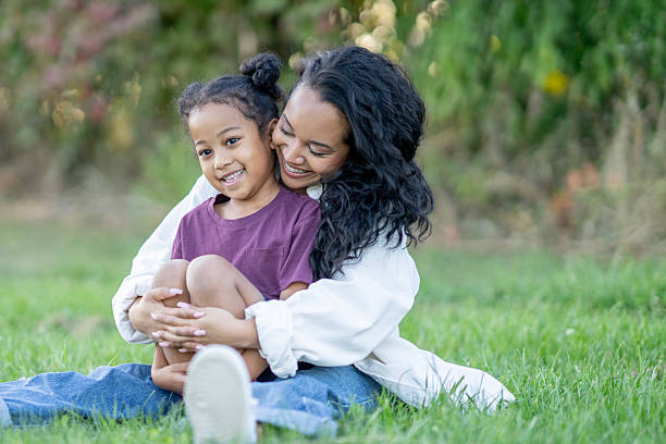 istock Mother and Daughter Bonding Outdoors in a Green Park Setting 2235942188