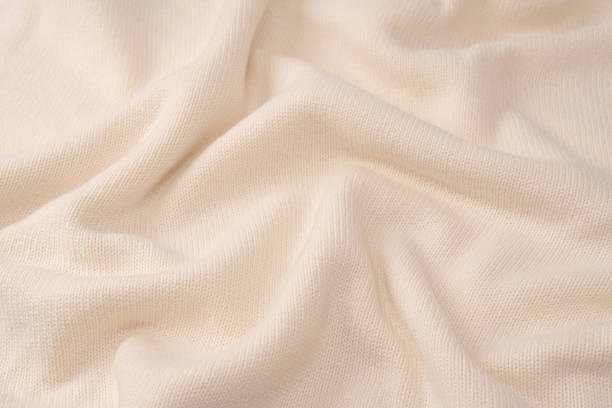 istock Soft milky color merino wool sweater texture as a background. 2235942697