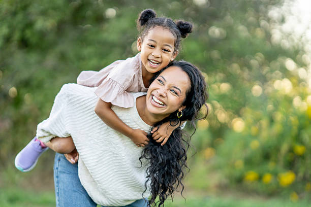 istock Joyful Mother and Daughter Bonding Outdoors in a Sunny Park Setting 2235943217