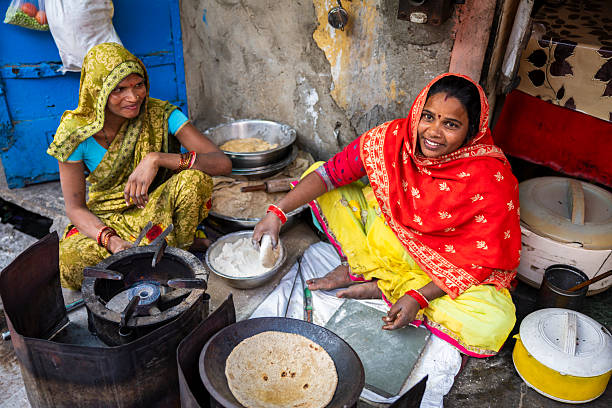 istock Indian women preparing food - chapatti, flat bread 2235944688