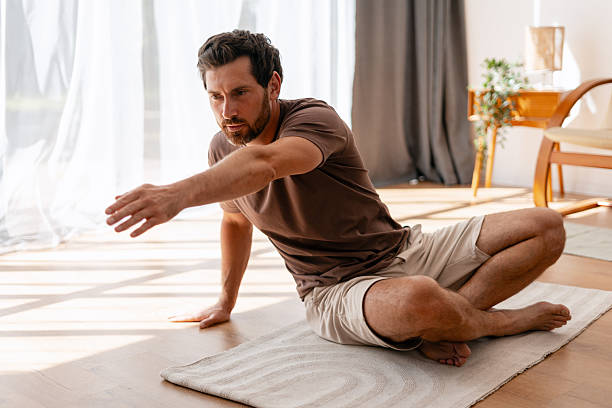istock Man practicing yoga in his living room 2235944913