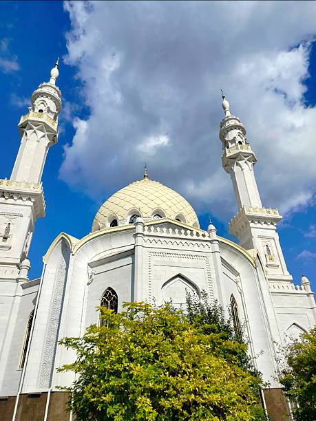 istock White Mosque with Twin Minarets Under a Blue Sky 2235945222