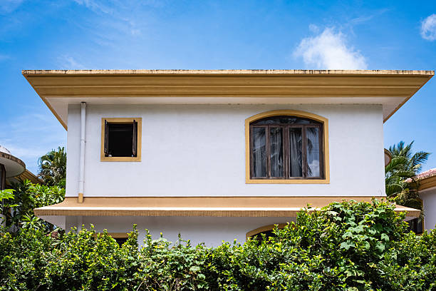 istock Front facade modern villa house with windows in tropical rainforest greenery landscape. 2235946109
