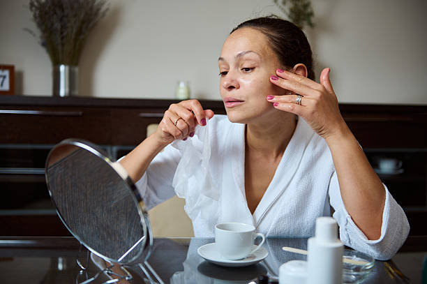 istock Woman Applying Skincare Routine in Modern Interior Setting 2235948450