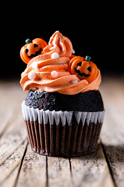 istock Halloween cupcakes with pumpkin decoration 2235950276