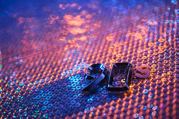 Shiny 90s Numbers onn Colorful Sequin Surface with Neon Lighting