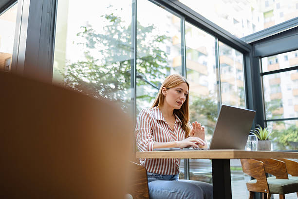 istock Young woman working on a laptop computer 2235953409