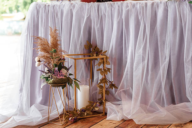 istock Table with a white cloth and a candle in a gold frame 2235953799