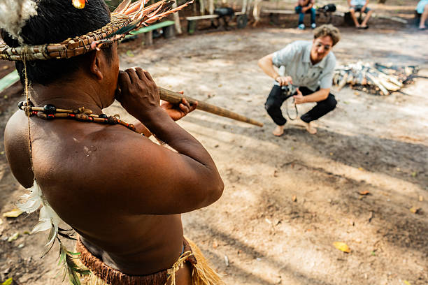 Curripaco indigenous playing yapurutu flute in traditional cultural presentation
