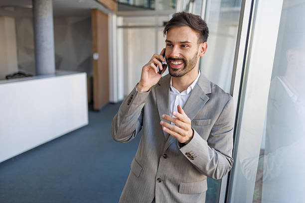 istock Businessman talking on phone in modern office building 2235956704