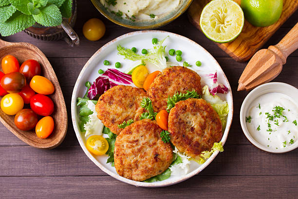 istock Fish patty burgers served with vegetables. Fish cakes 2235957687