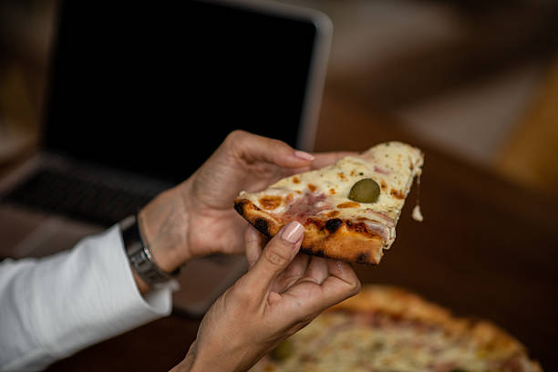 istock Pizza slice close up in hand 2235957931