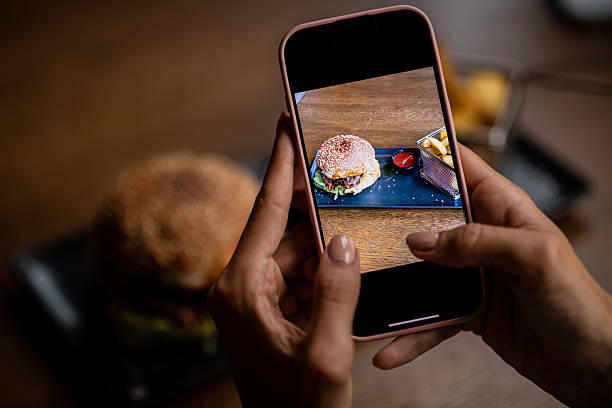 istock Taking a photo of a burger meal 2235958096