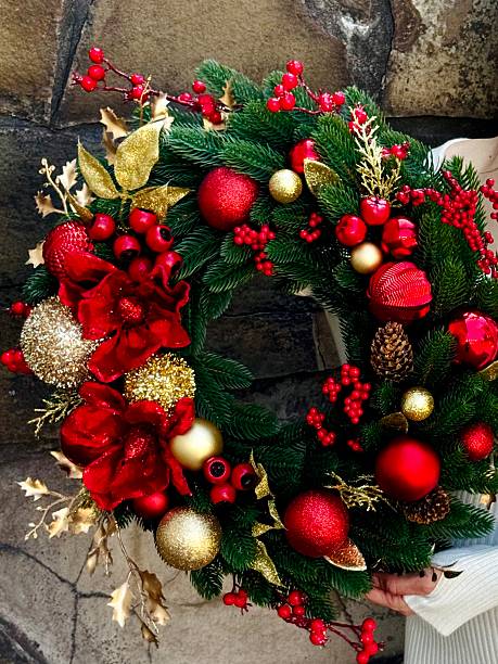 istock christmas wreath with red and gold ornaments 2235959028
