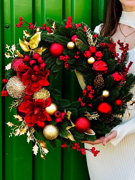 istock christmas wreath with red and gold ornaments 2235959037