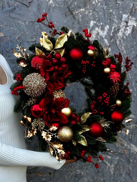 istock christmas wreath with red and gold ornaments 2235959093