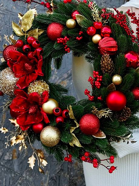 istock christmas wreath with red and gold ornaments 2235959099