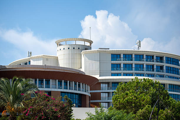 istock Modern Building Complex Exterior with Trees and Cloudy Sky 2235960317