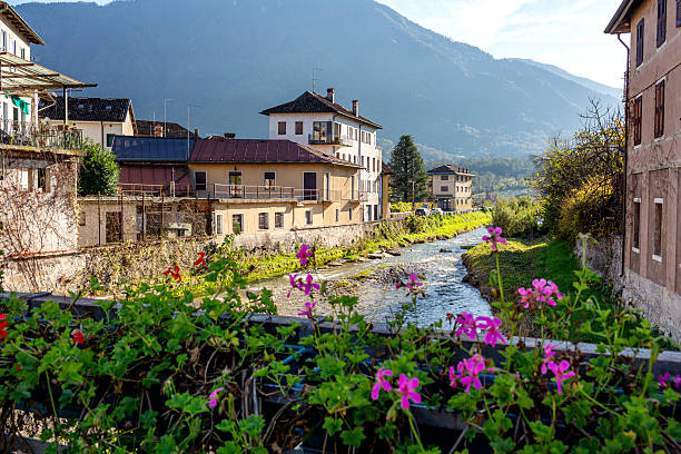 istock A picturesque view from the bridge over a tranquil river flowing through lush green countryside in the historic center of Feltre in the province of Belluno, Veneto, Italy, with mountains in the background and charming buildings lining the riverbank. 2235960762