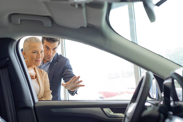 istock Married Couple in a Car Showroom 2235962399