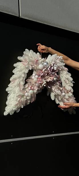istock christmas wreath in the shape of wings 2235963771