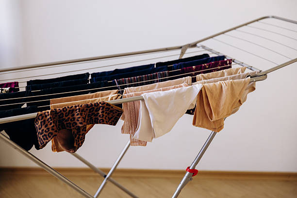 istock Wet laundry is hanging on the drying rack. 2235967634