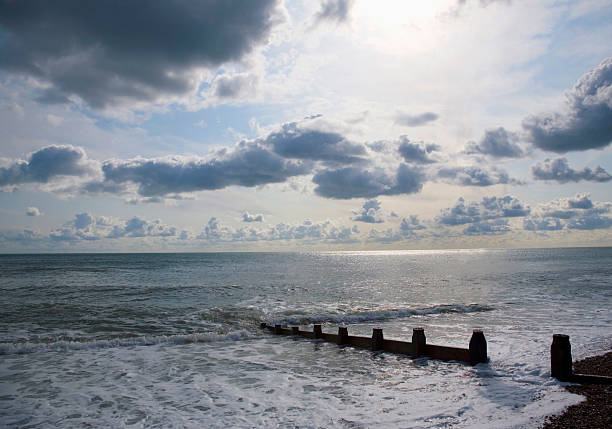 Dramatic sky over Pomorie town and fishers on the Jetty. Bulgaria, Eastern Europe.
