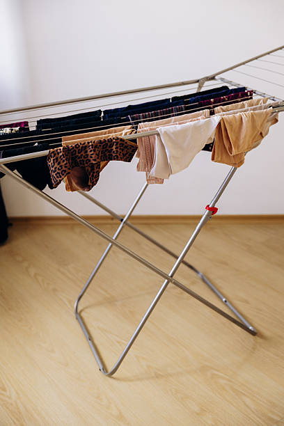 istock Wet laundry is hanging on the drying rack. 2235967809