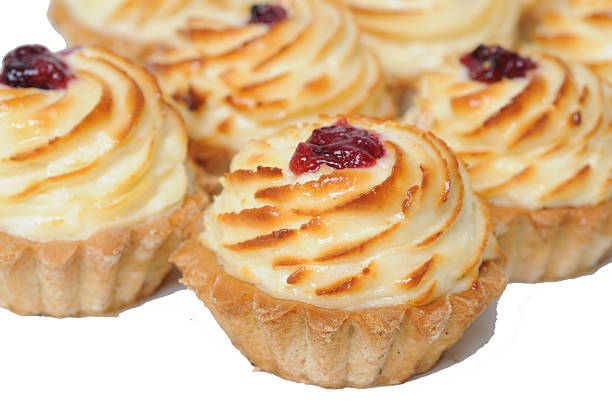 Cheese tartlets with cherry jam on a white background. Confectionery.