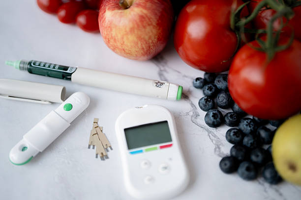 istock Diabetes Management Tools with Fresh Fruits on Marble Tabletop 2235968528