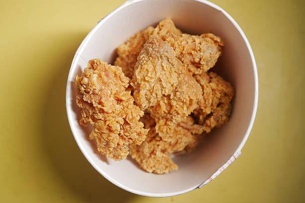 istock Crispy fried chicken served in a bowl on a yellow surface 2235968724