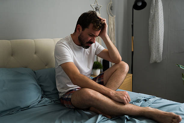 istock Worried man suffering from breakup sitting on bed 2235968826