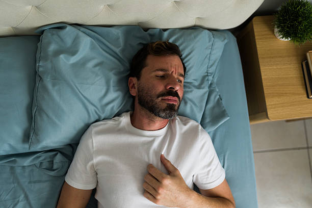 istock Depressed man lying in bed after breakup, experiencing heartbreak and anxiety 2235969824