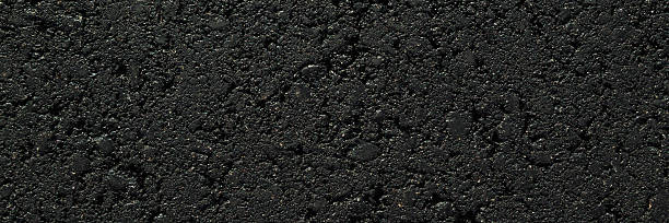 istock New dark black asphalt background. Closeup. Wide banner. Empty place for text. Top down view. 2235971027