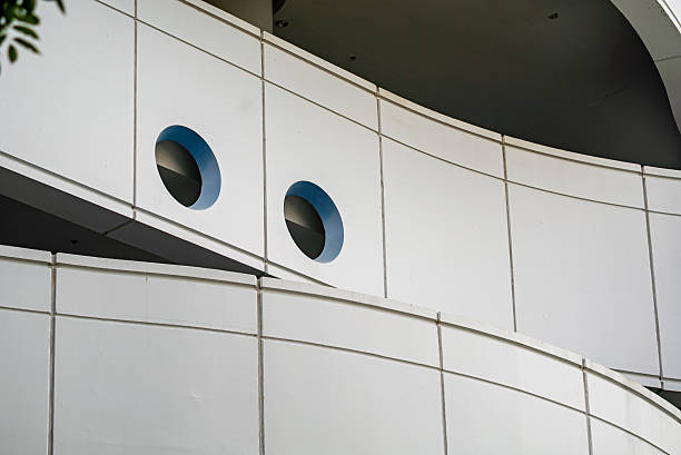 This image showcases a modern architectural detail featuring smooth curves and circular blue accents, highlighting contemporary design and innovative structure.