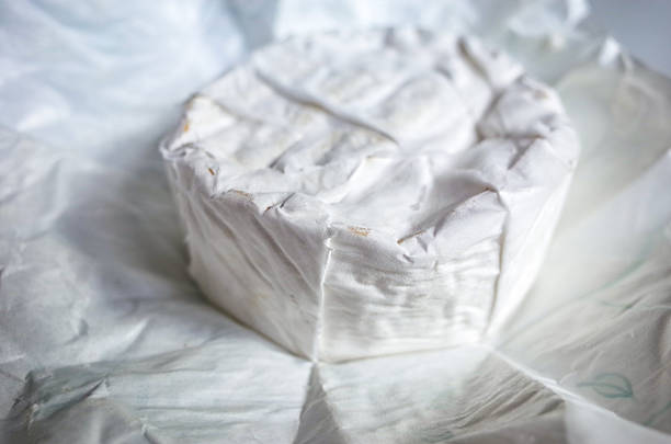 Piece of Brillat-savarin close-up isolated on white background