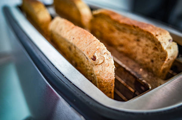 istock Slices of Bread in Toaster Breakfast Moment 2235973710