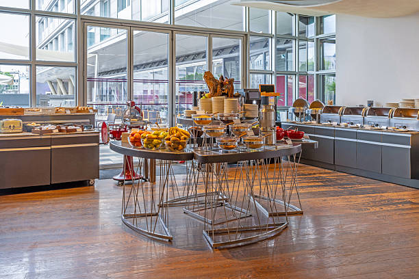 istock Bright breakfast room interior with buffet tables laden with assorted dishes 2235976575