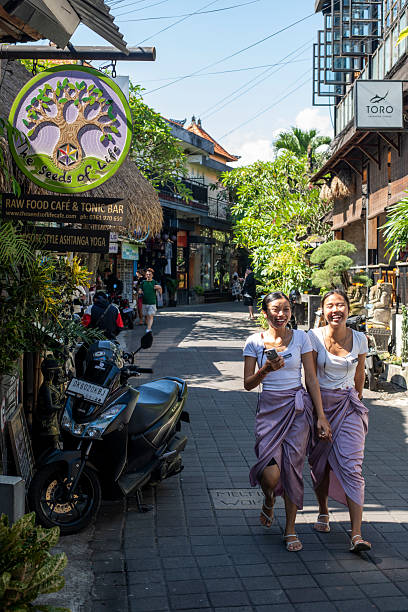 Two colleagues laugh as they walk in Ubud, Bali (March 2, 2025)