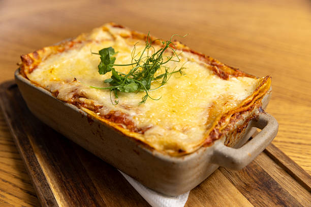 istock Lasagna served in a ceramic bowl on a wooden board 2235978216