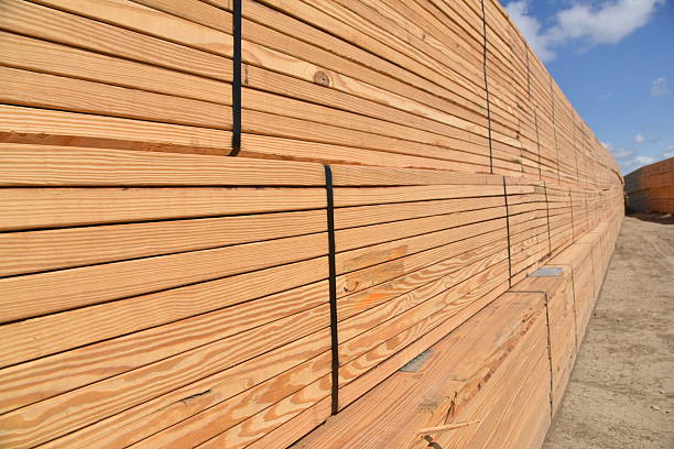 A front view of a large stacked pile of 2x4 beams, ready to aid in the framing of a new home build.  Valuable natural wood materials.