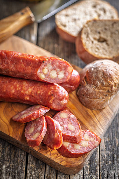 istock Sliced smoked sausage on cutting board. 2235985016