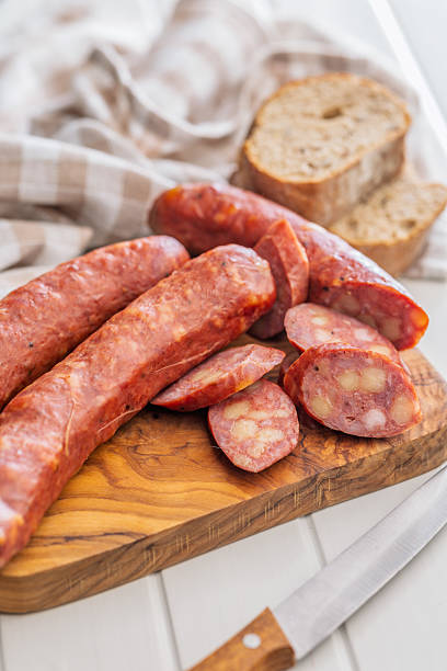 istock Sliced smoked sausage on cutting board. 2235985040