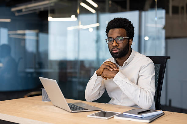 istock Professional man working with a laptop in a modern office setting 2235987319